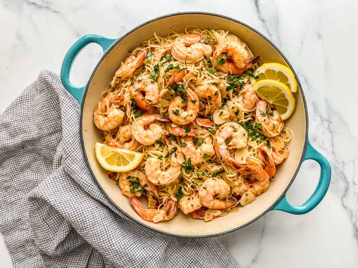 Shrimp seafood pasta in a skillet next to a napkin.