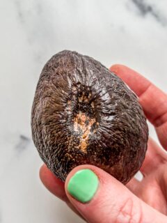 An avocado with a large divet.