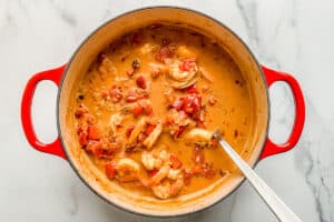 Coconut shrimp curry in a red pot.