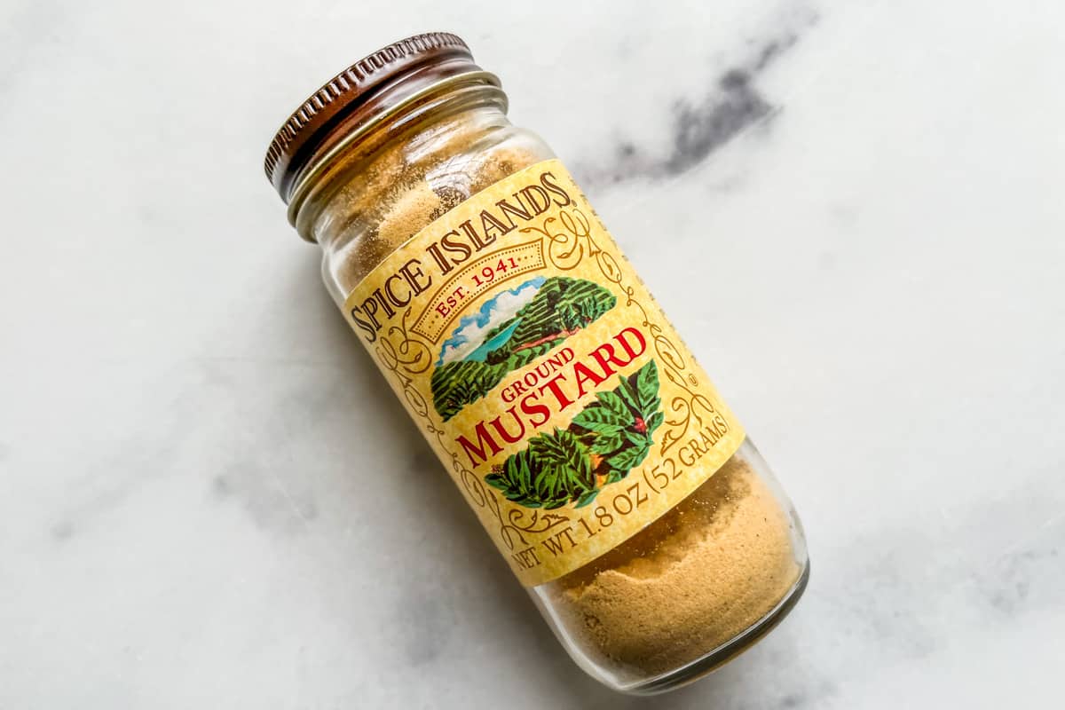 A spice jar of ground mustard.