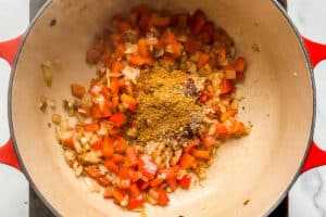 Vegetables and onions with spices in a pot.