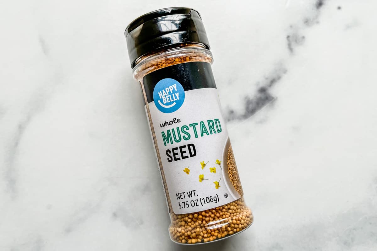 A spice bottle of mustard seeds.