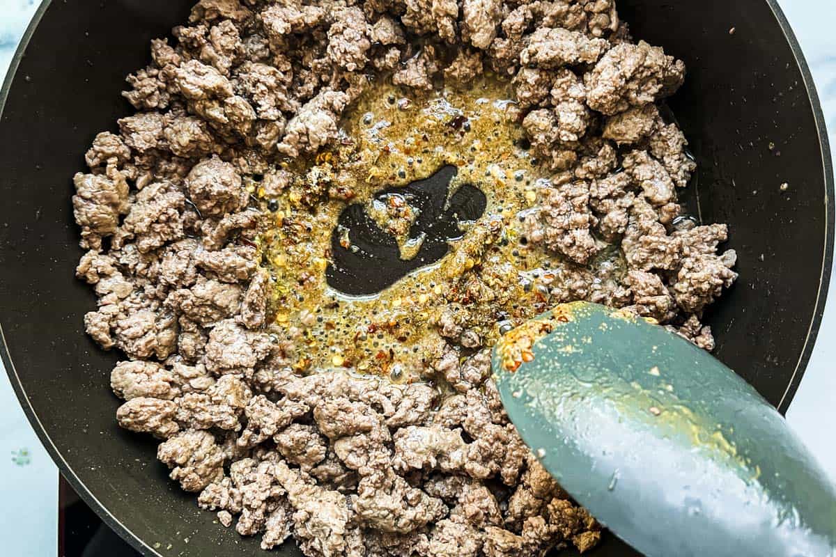 Ground beef being cooked with spices.