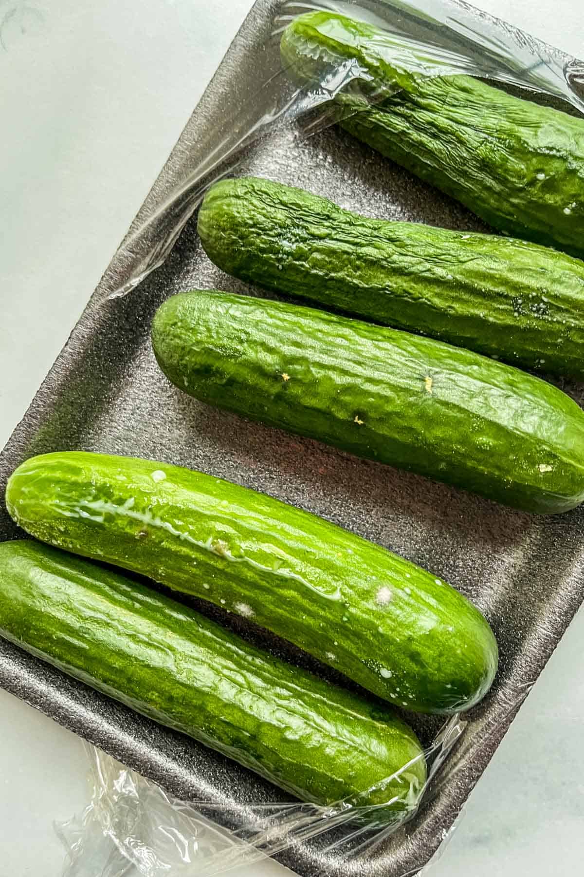 Several rotting cucumbers in a package.