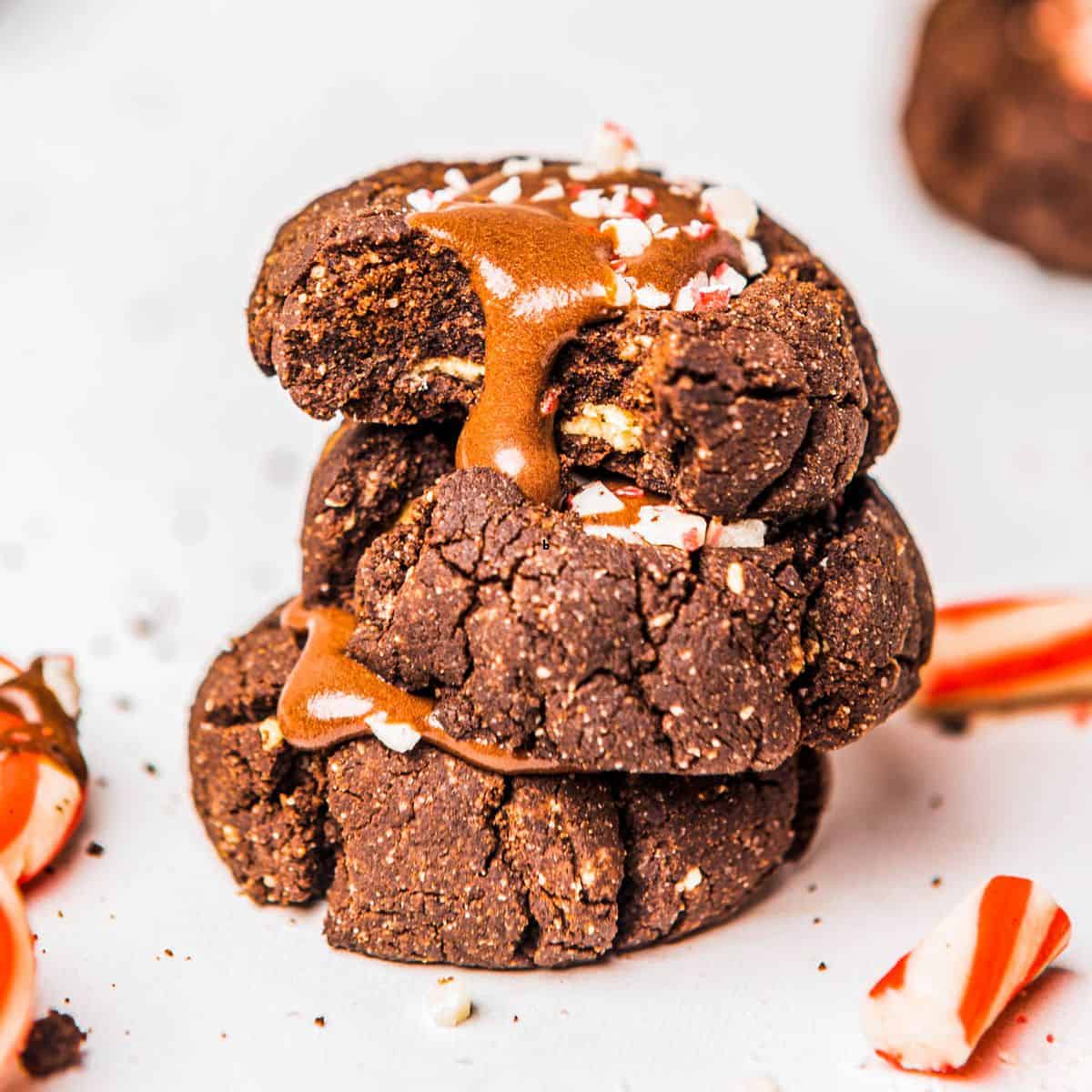 A stack of three healthier chocolate thumbprint cookies.