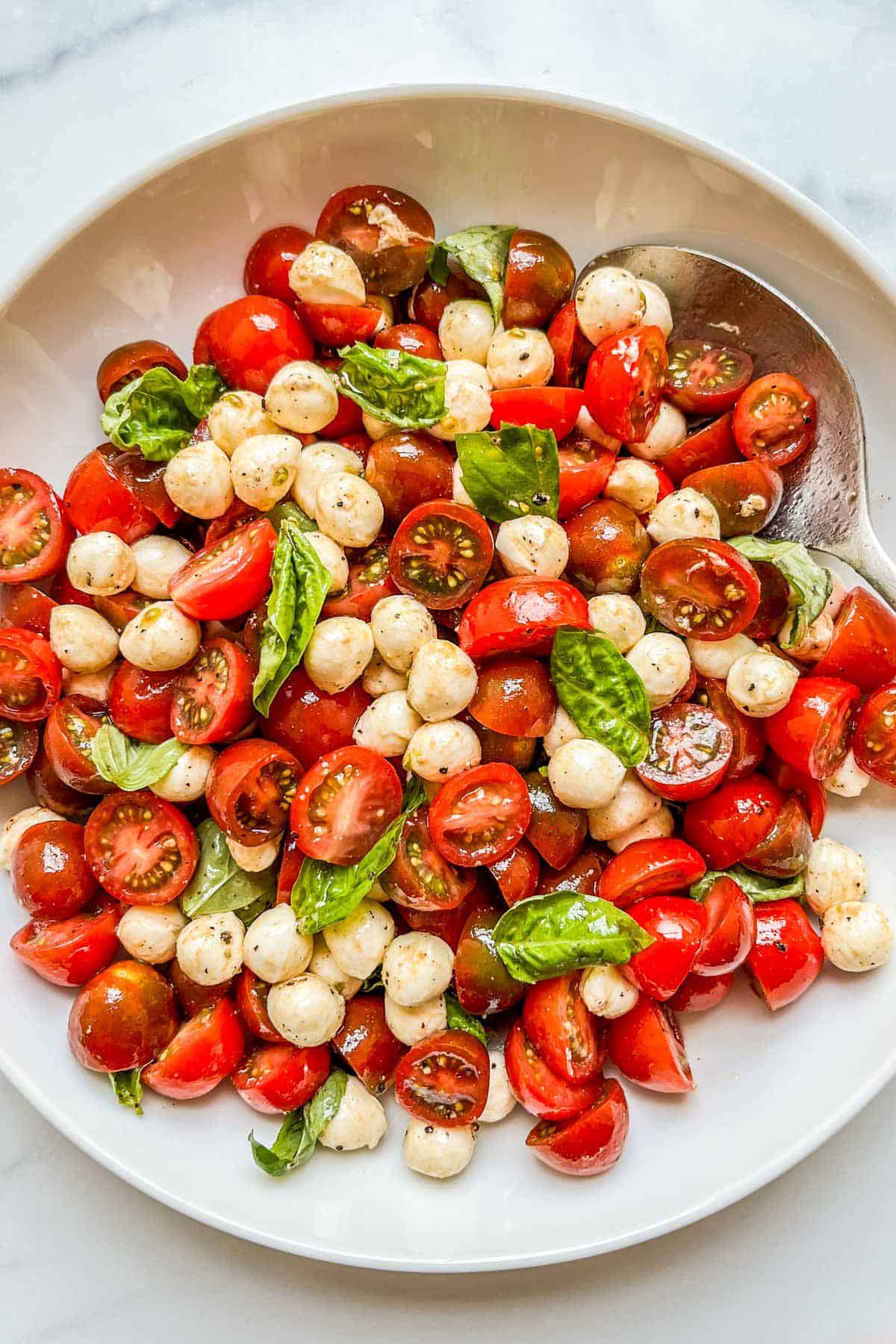 A large bowl of cherry tomato caprese salad.