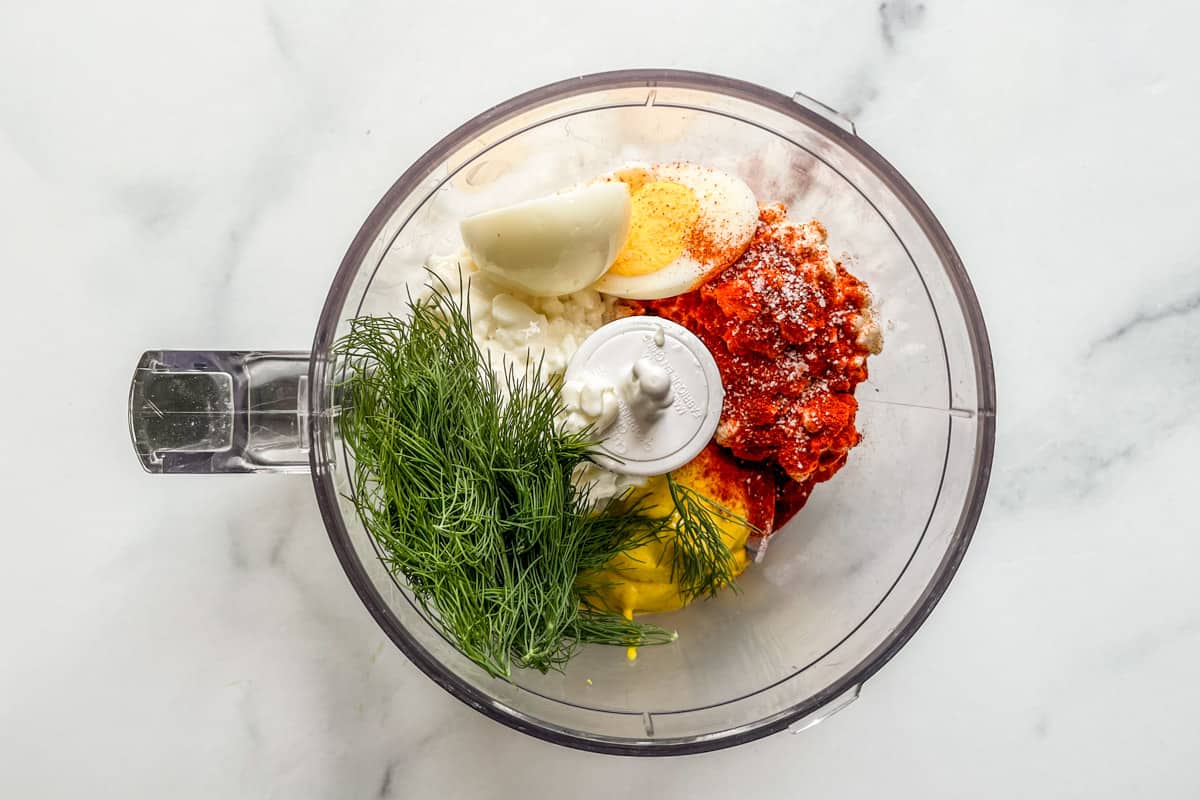 Cottage cheese, mustard, dill, a hard boiled egg, salt, and paprika in a food processor.