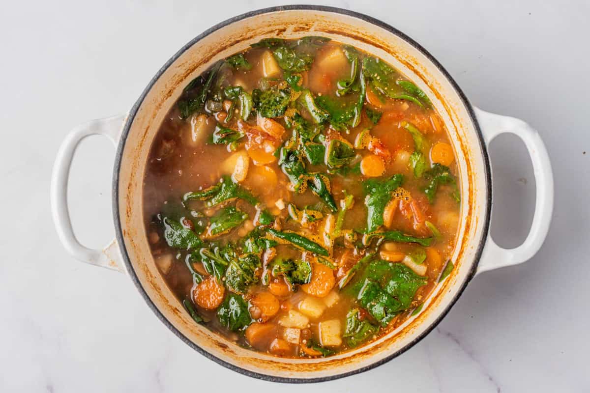 Mediterranean lentil soup cooking in a pot.