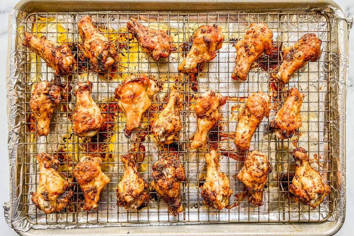 Baked chicken wings on a sheet pan.