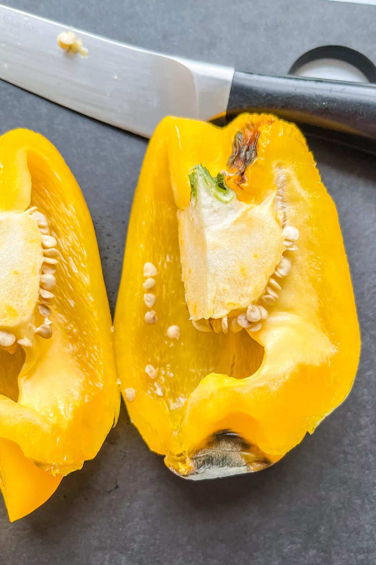 The interior of a yellow bell pepper with mold.