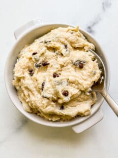 Cottage cheese cookie dough in a white ramekin with a silver spoon.