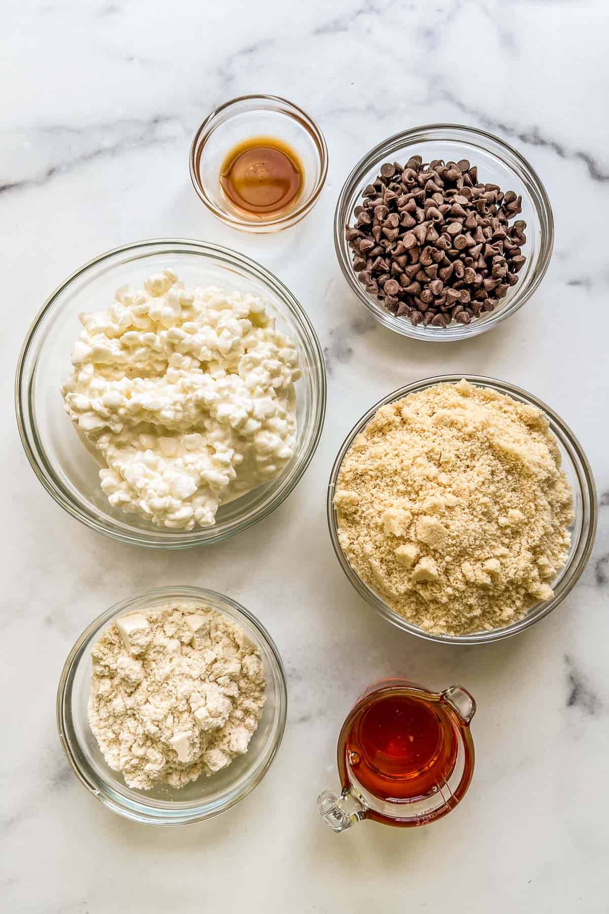 Ingredients for cottage cheese cookie dough in glass bowls.