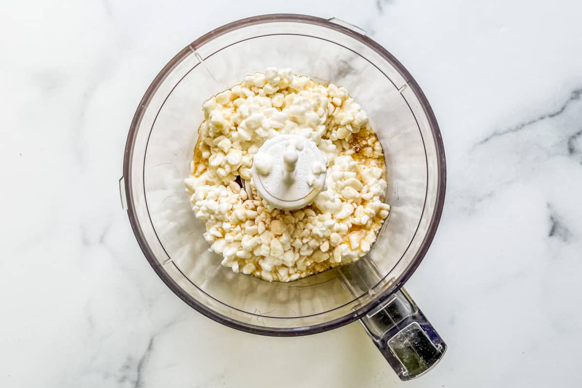 Cottage cheese, maple syrup, and vanilla in a food processor.