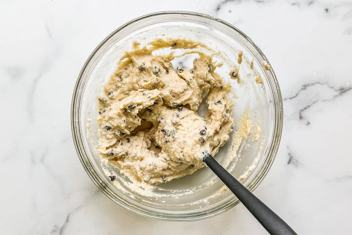 Mixing cottage cheese protein cookie dough in a glass bowl.