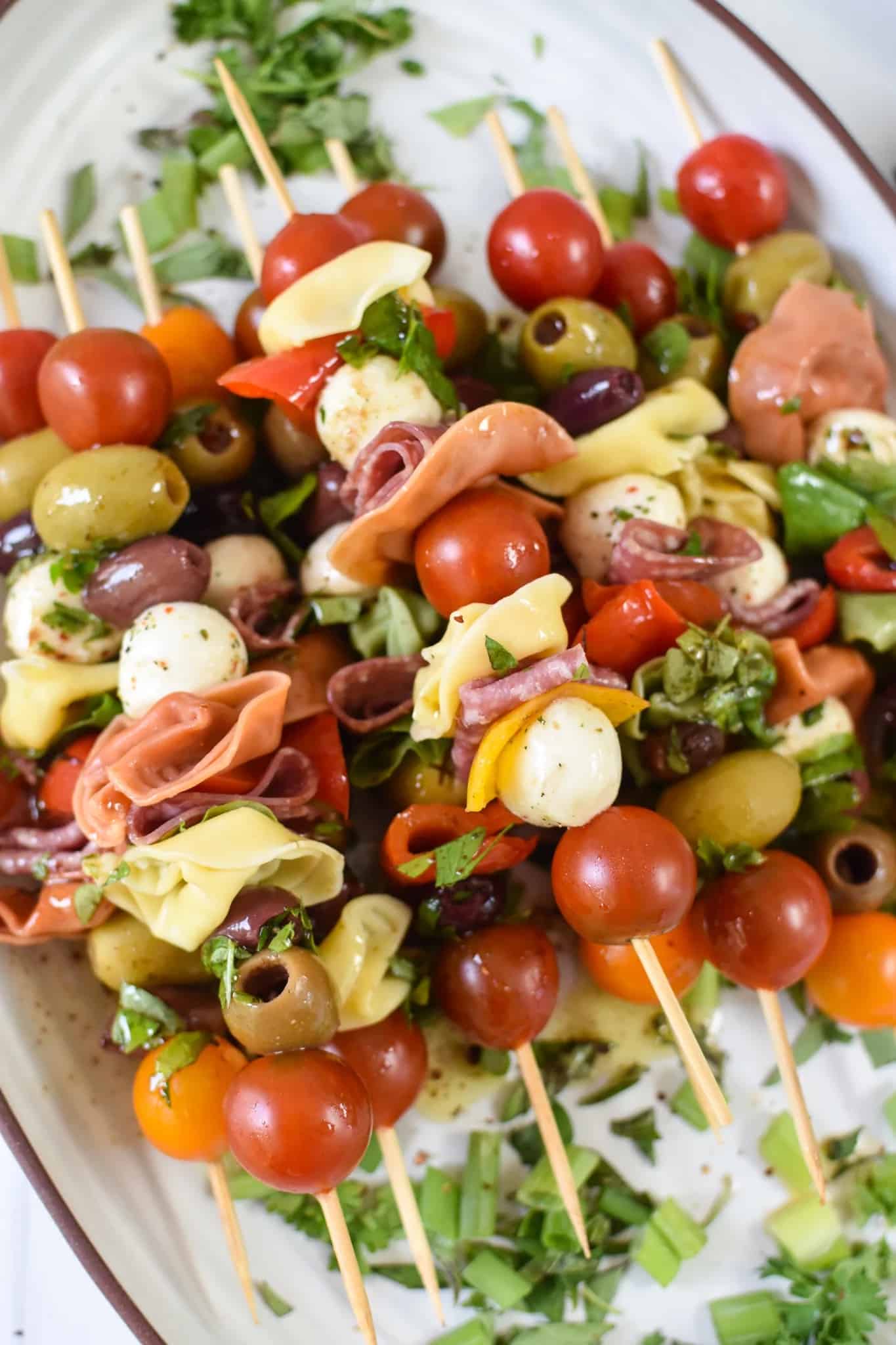 A stack of antipasto skewers on a plate.