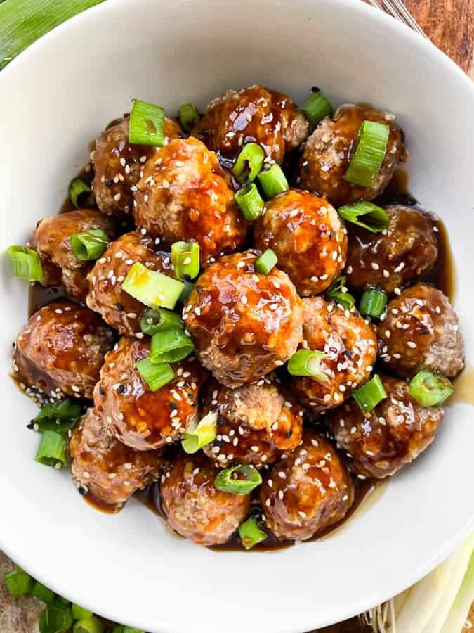 Asian chicken meatballs in a white bowl.