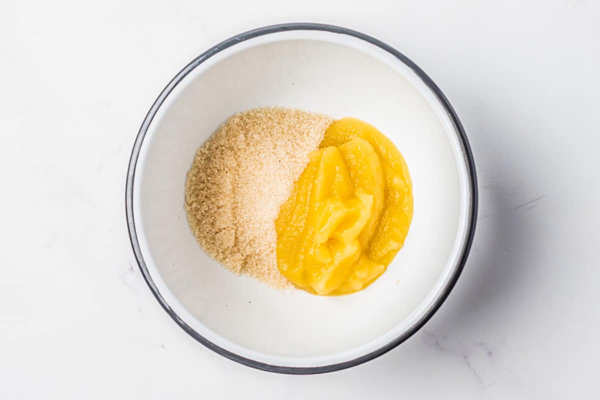 Coconut sugar and applesauce in a mixing bowl.