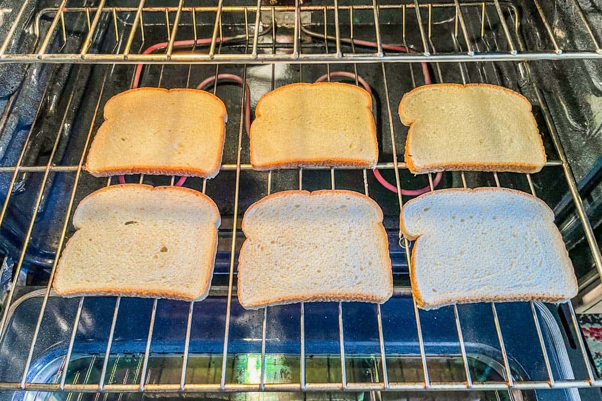 Six pieces of white bread in an oven.