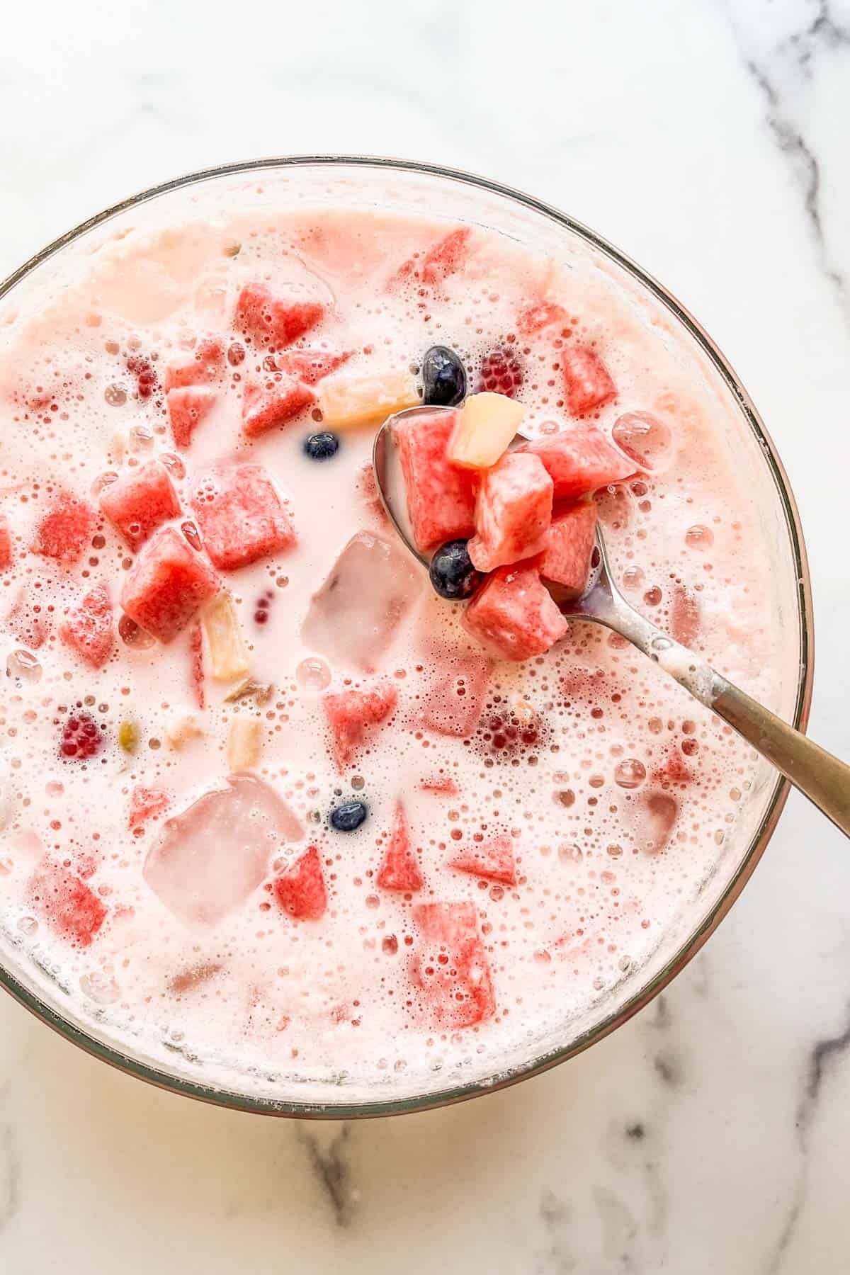 Korean hwachae strawberry punch in a glass bowl.