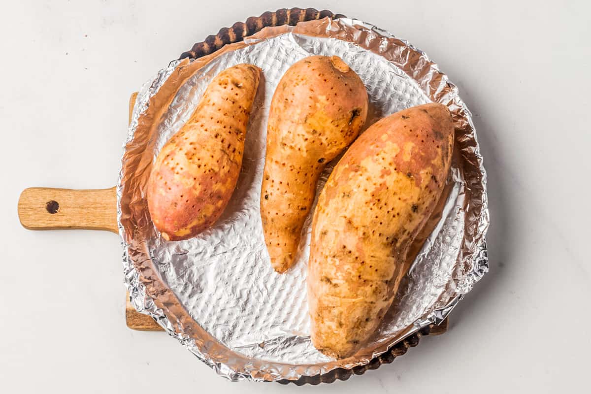 Sweet potatoes on a foil lined baking dish.