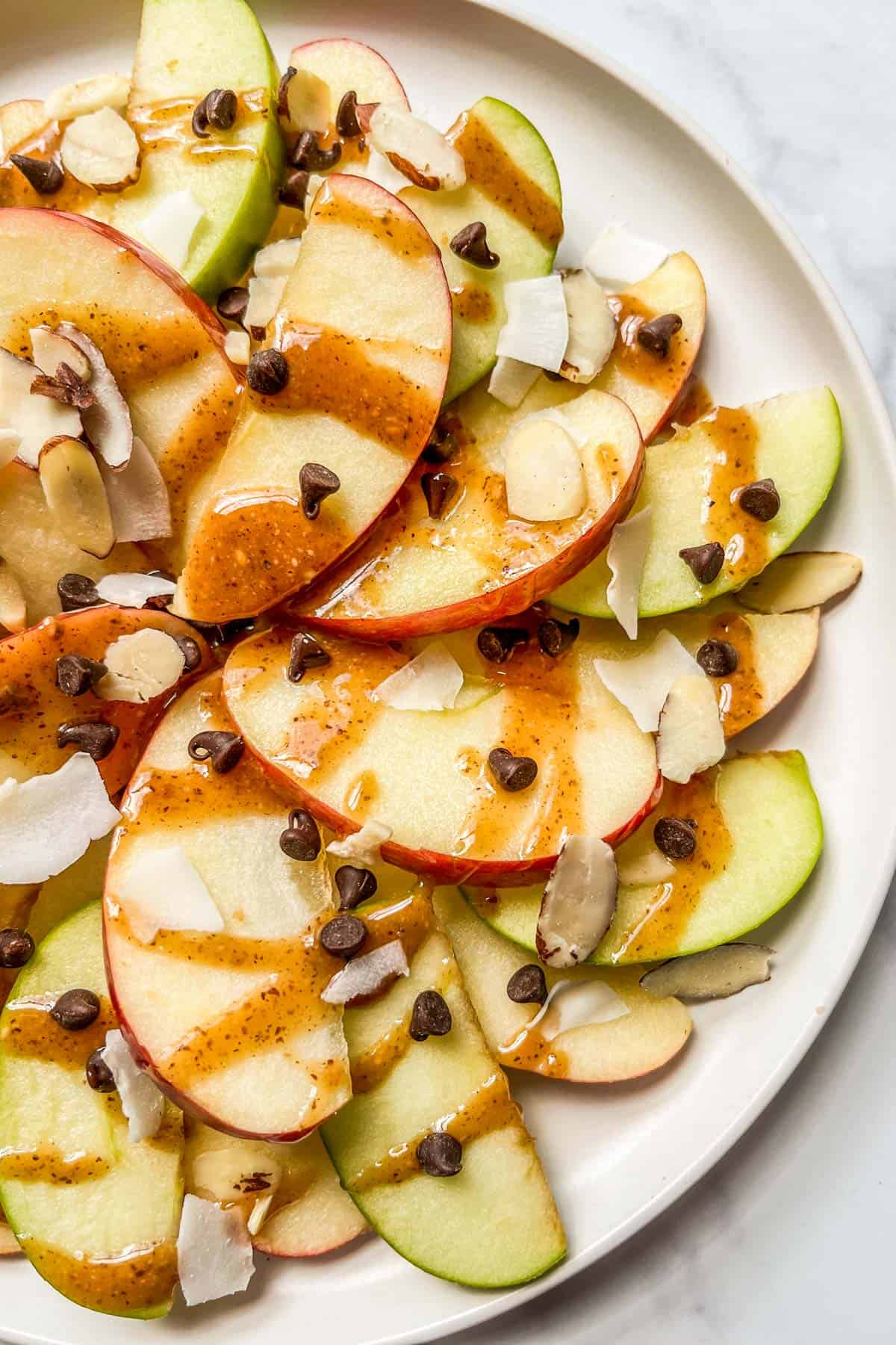 Apple nachos on a white plate.