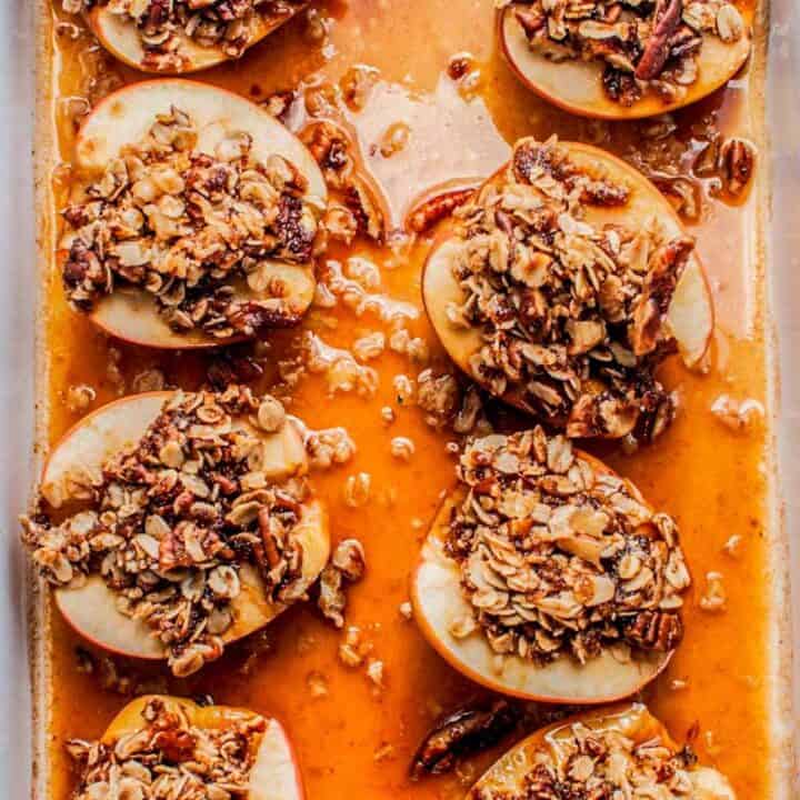 Baked apples with oatmeal in a white pan.