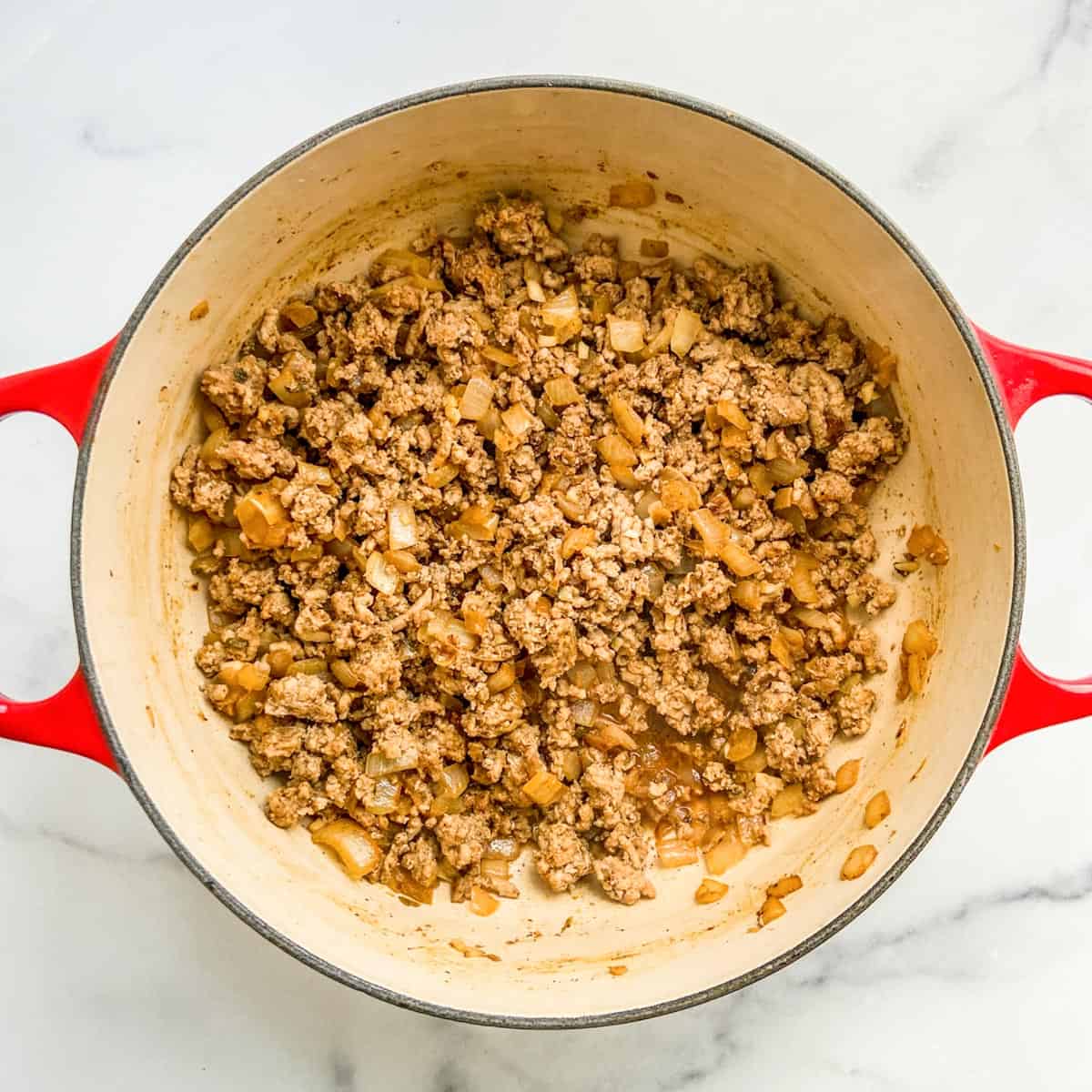 Browned ground turkey and onions in a pot.
