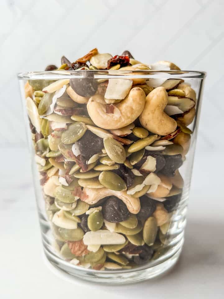 Healthy trail mix in a glass cup.