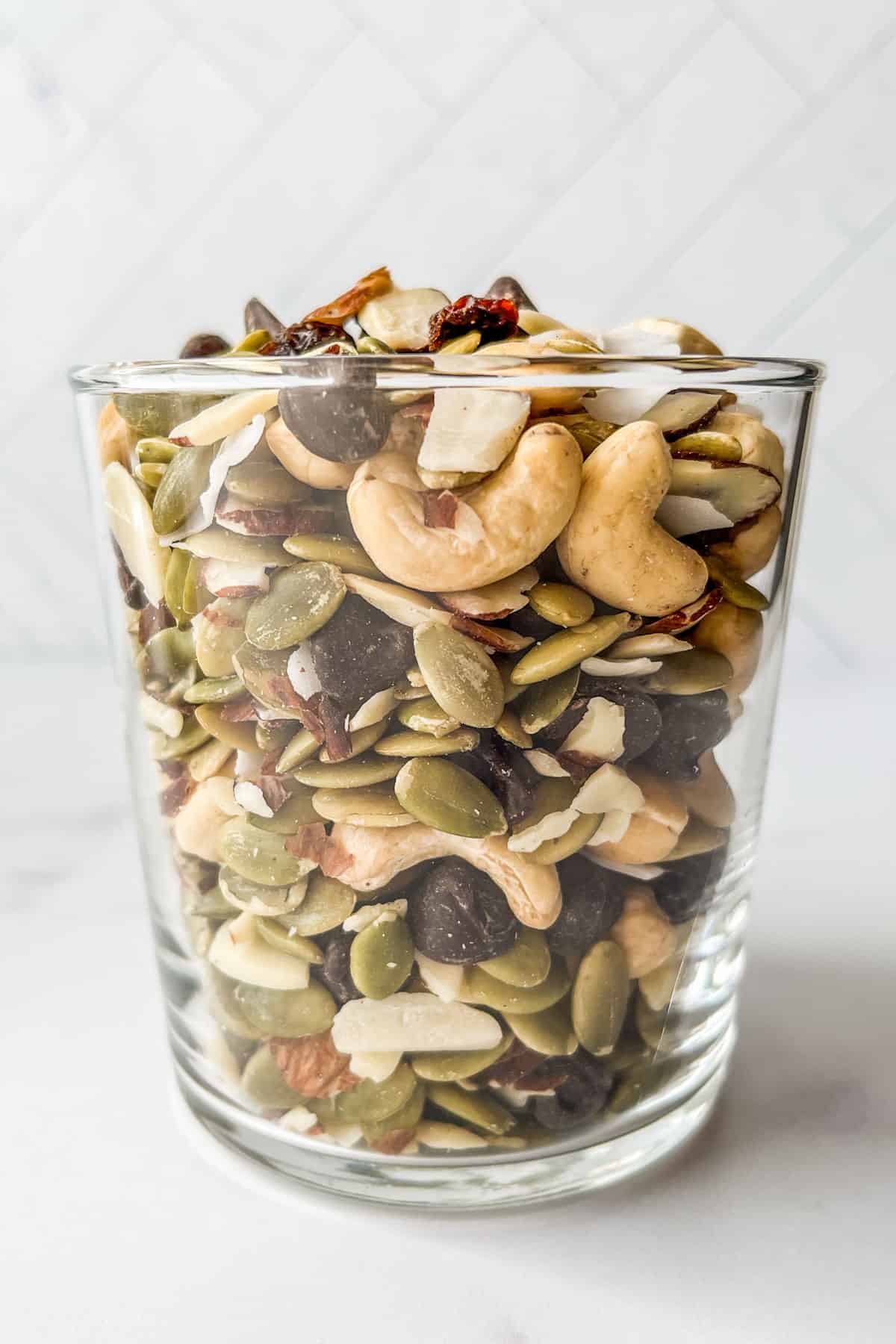 Healthy trail mix in a glass cup.