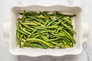 Green beans in white casserole dish.