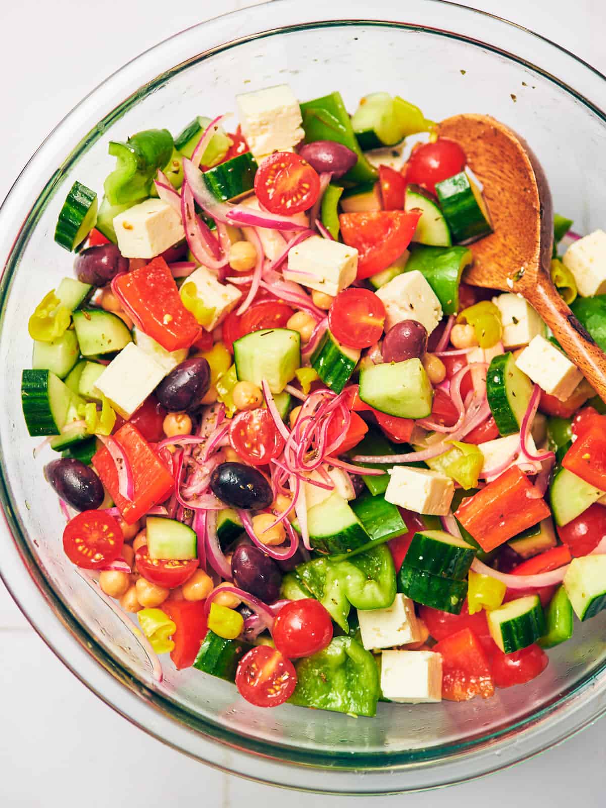 Greek salad in a large glass bowl.