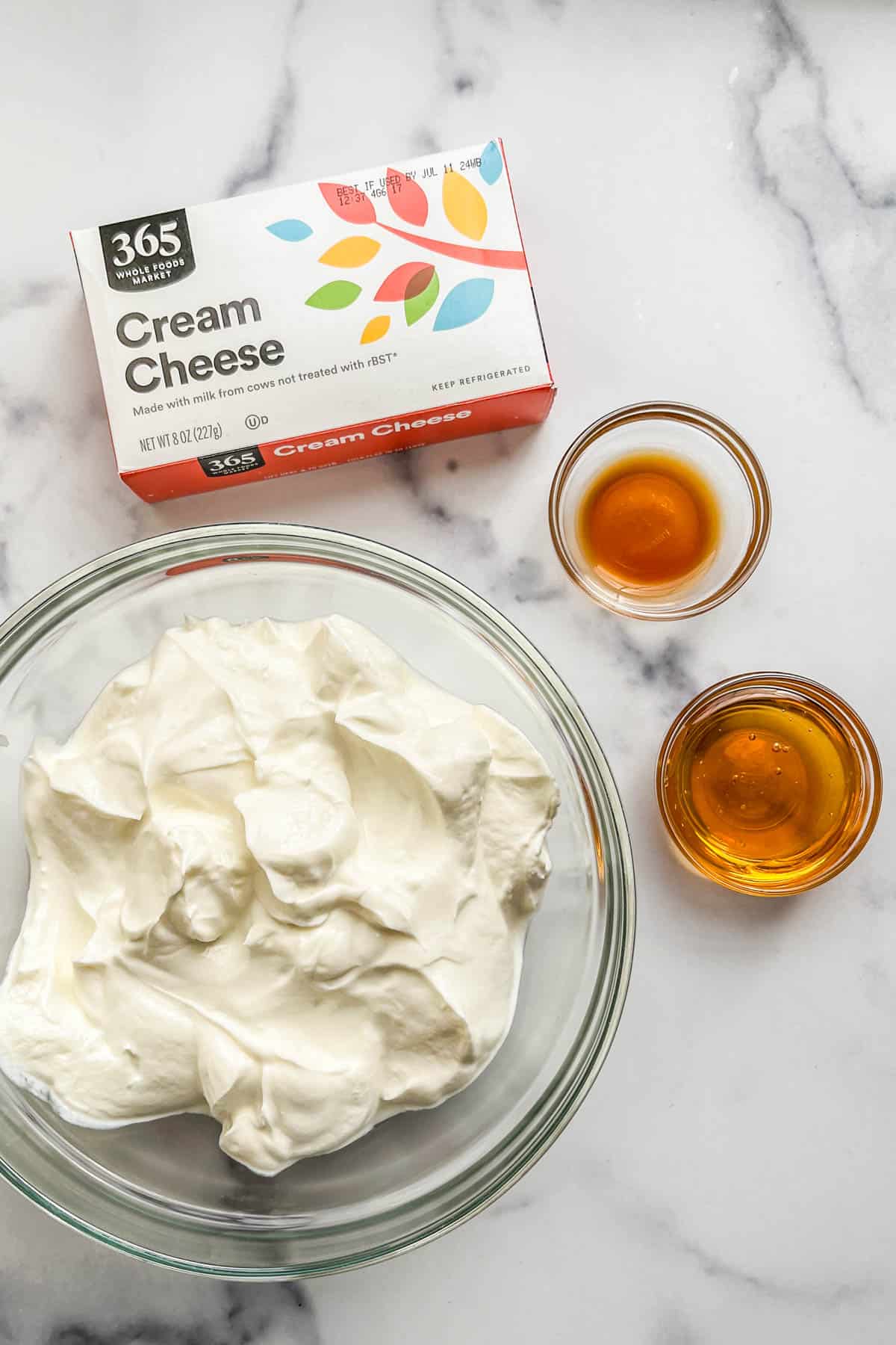 Cream cheese, Greek yogurt, honey, and vanilla extract in bowls.