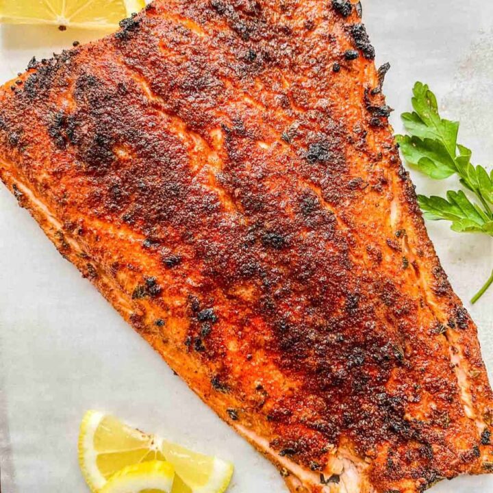 Broiled salmon fillet on parchment paper.