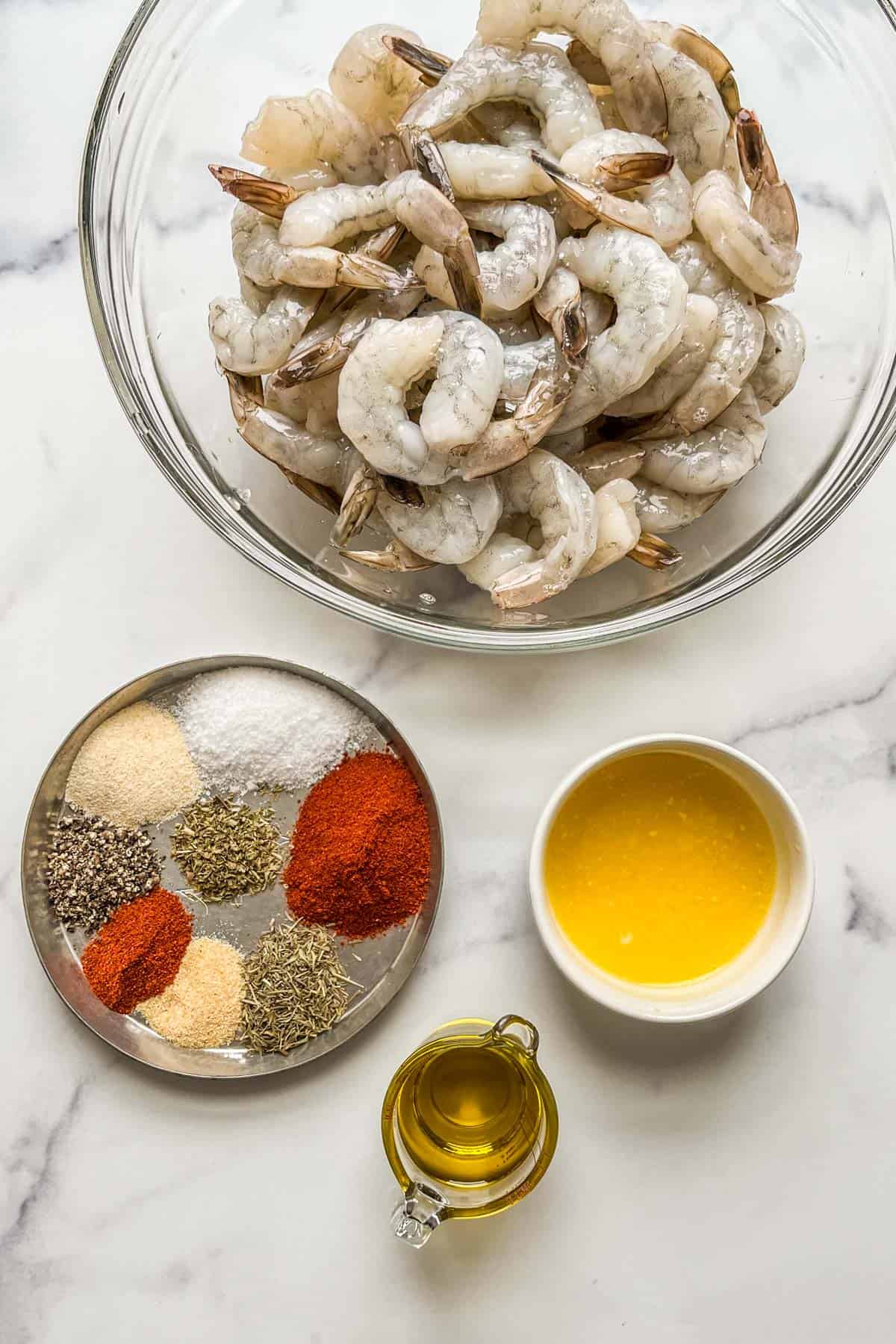 Blackened shrimp ingredients on a marble background.