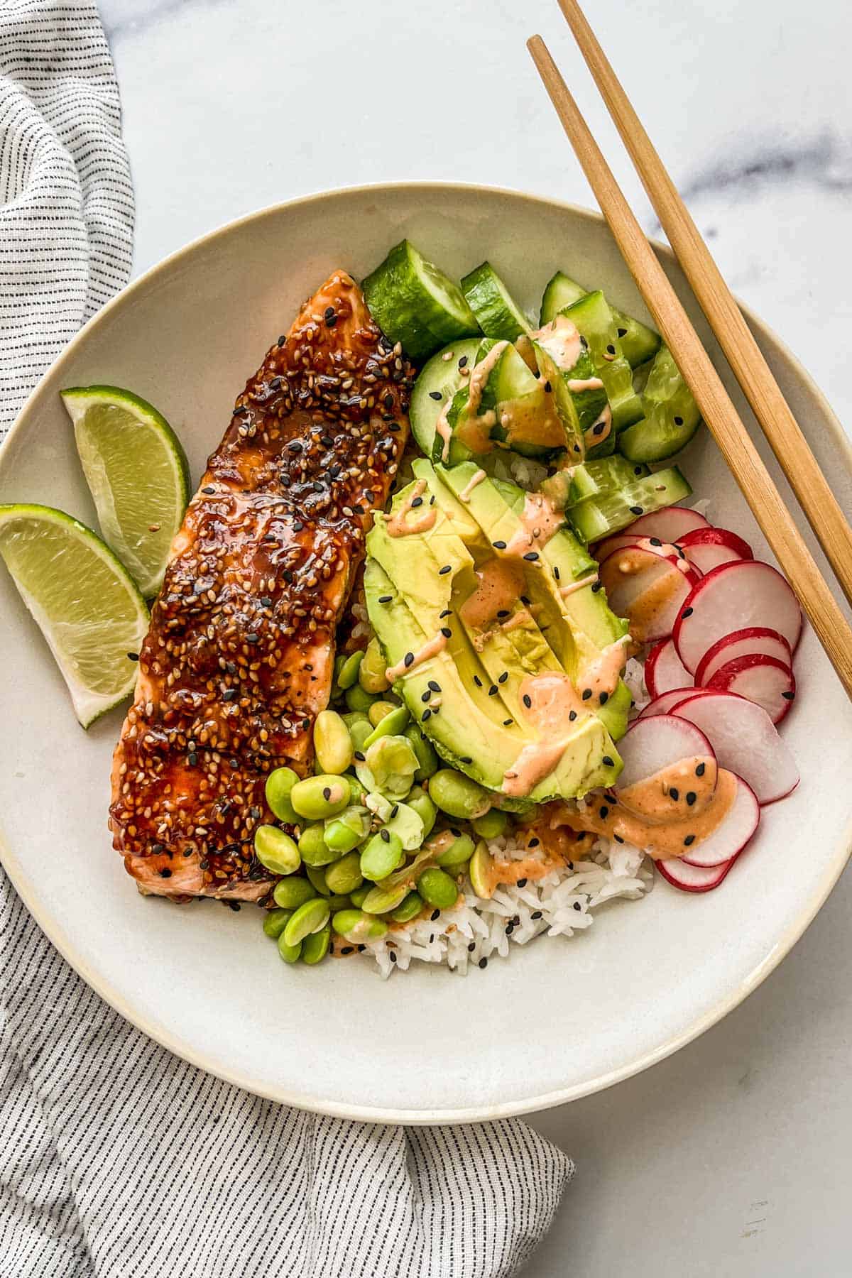 Teriyaki salmon in a bowl with rice and vegetables.