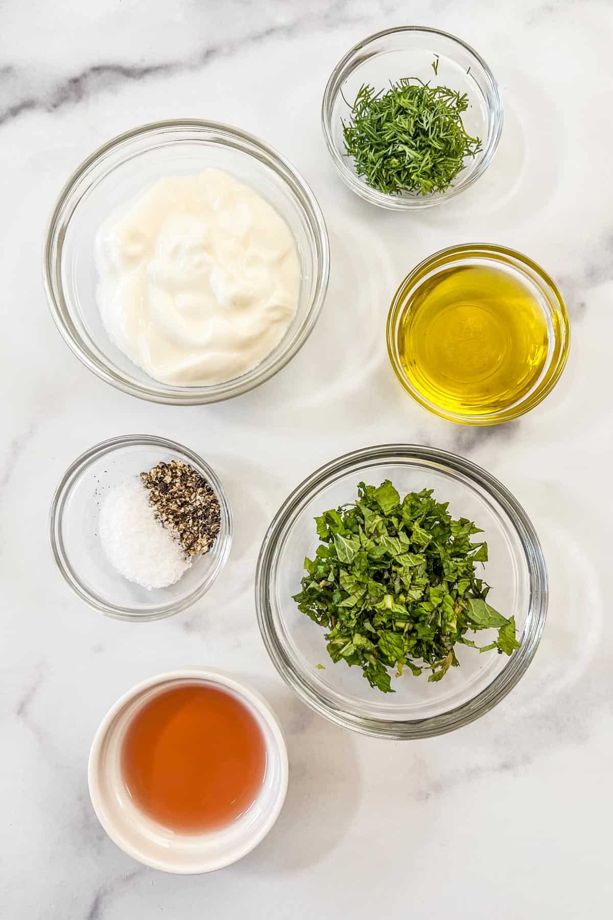 Yogurt dill salad dressing ingredients in small bowls.