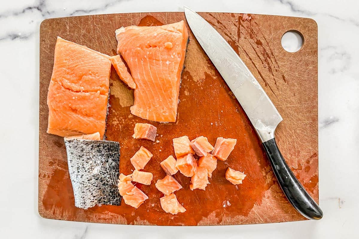 Sliced salmon on a cutting board.