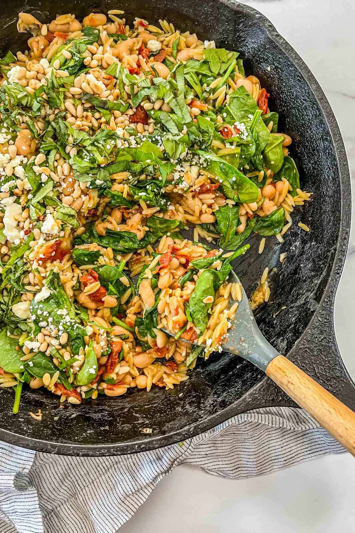 One pot skillet orzo and white beans with spinach and sun dried tomatoes.
