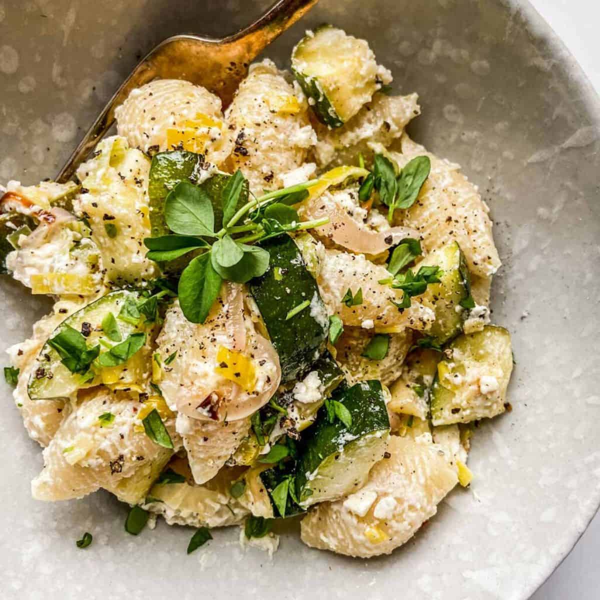Baked feta and zucchini pasta in a bowl.