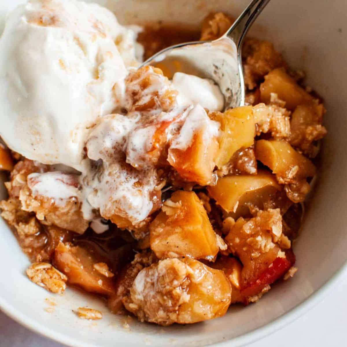Caramelized apple crisp with a scoop of ice cream.