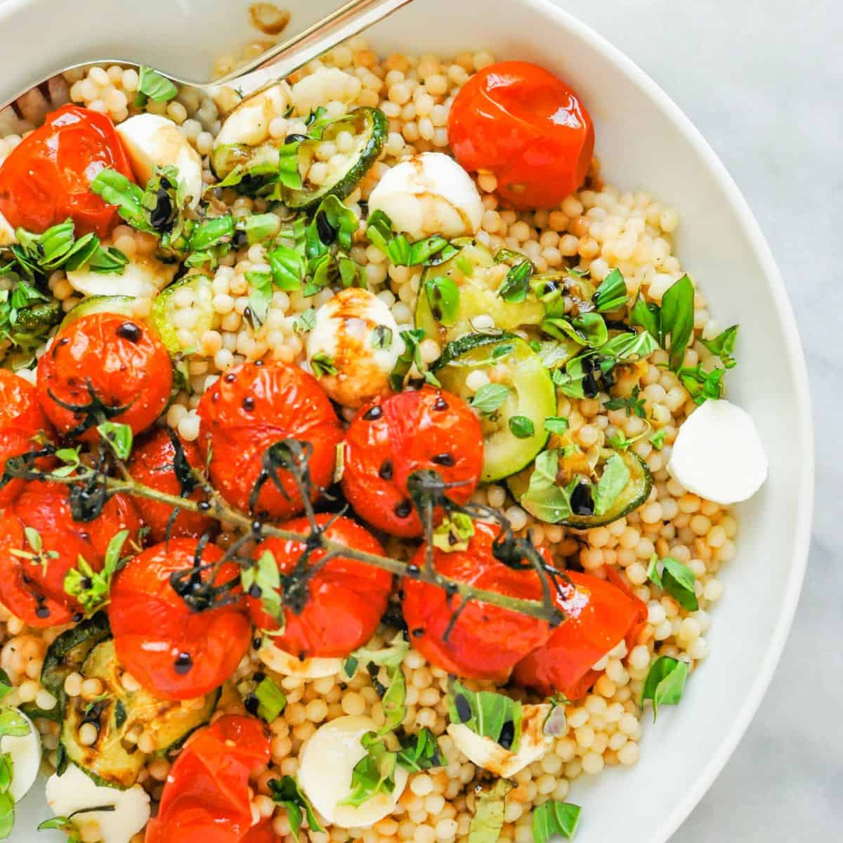 Pearl couscous salad with zucchini and tomatoes.