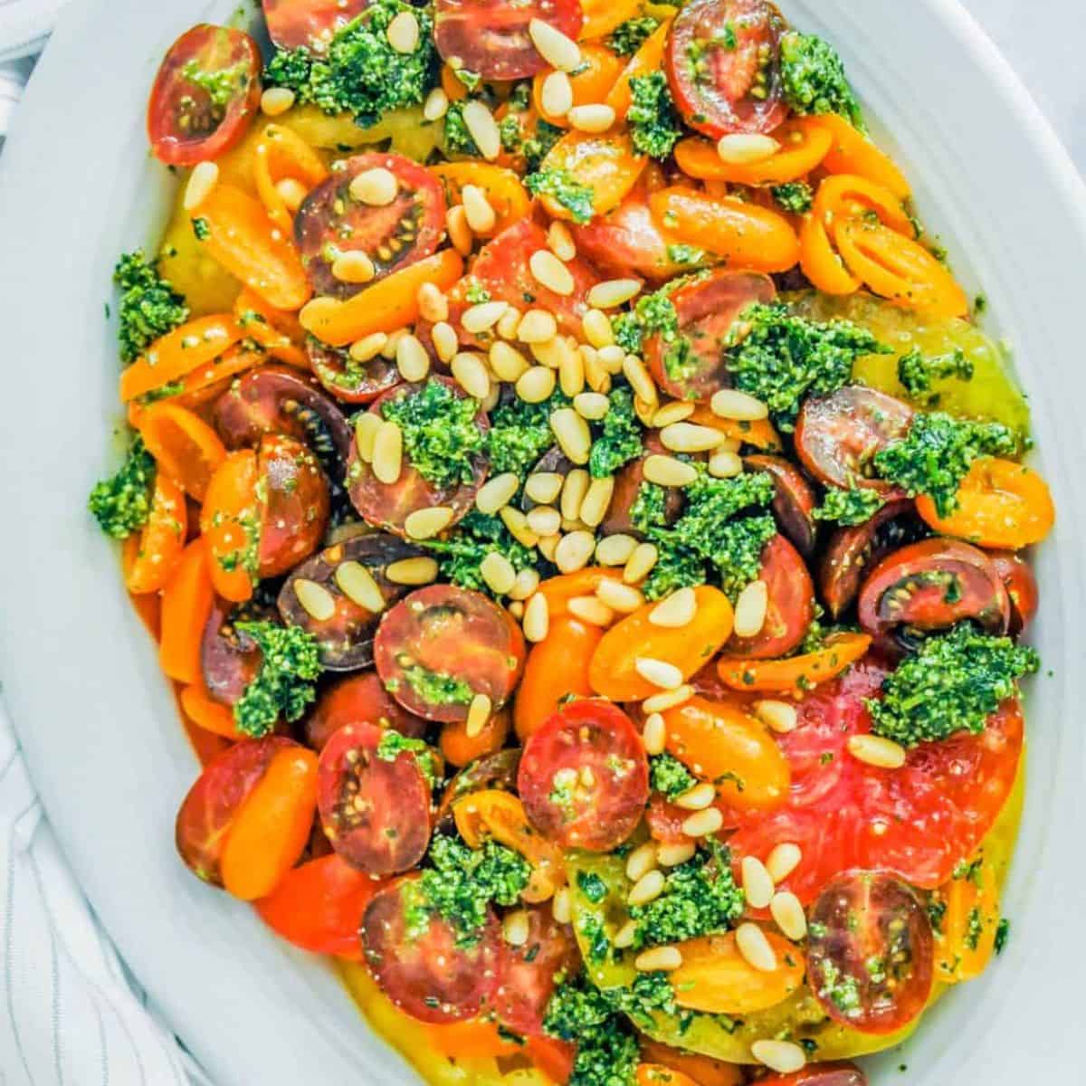 Tomato tarragon salad on a white platter.