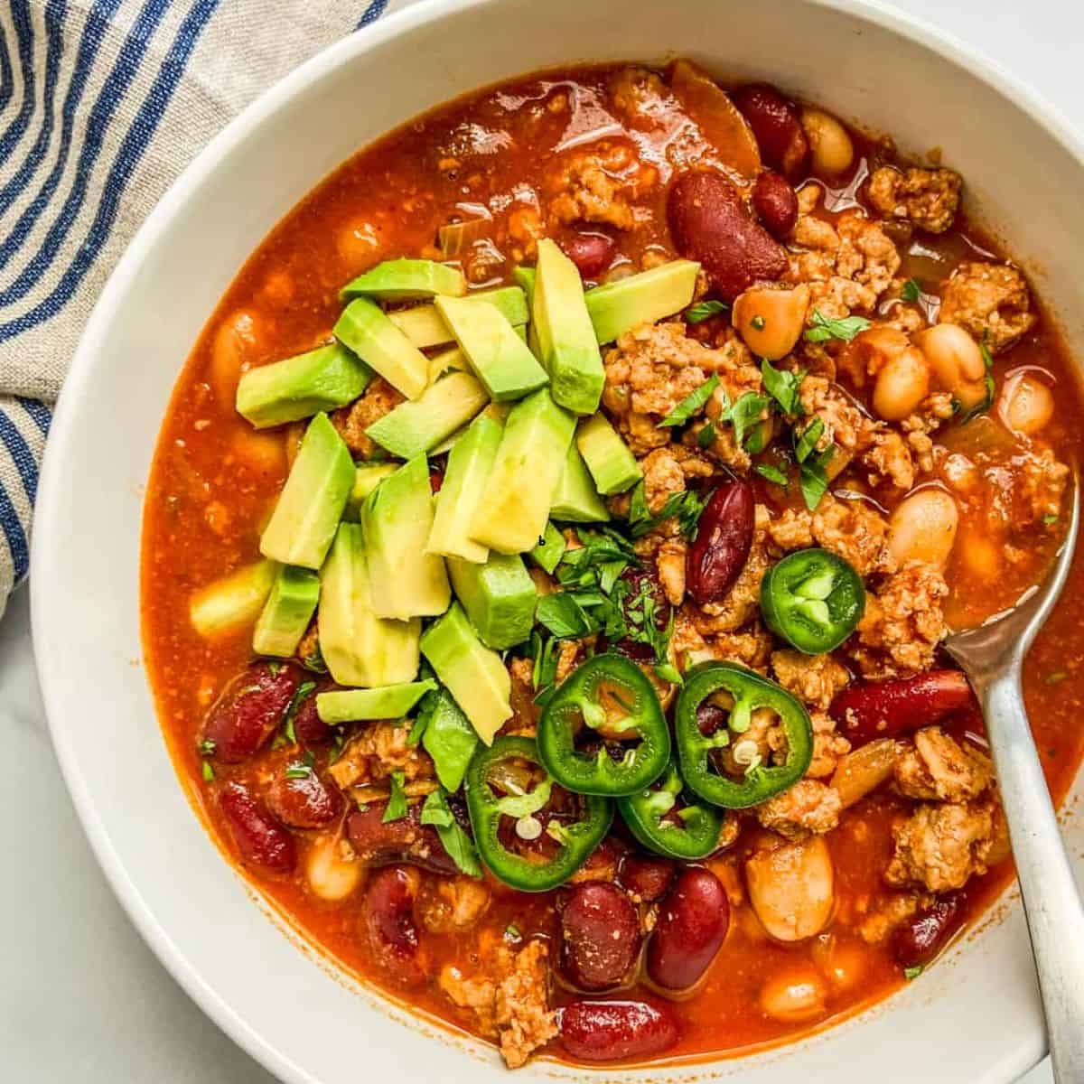 Ground turkey chili topped with avocado and jalapeno.