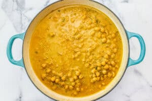 Chickpea curry cooking in a large skillet.