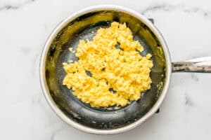 Cottage cheese eggs cooked in a small frying pan.