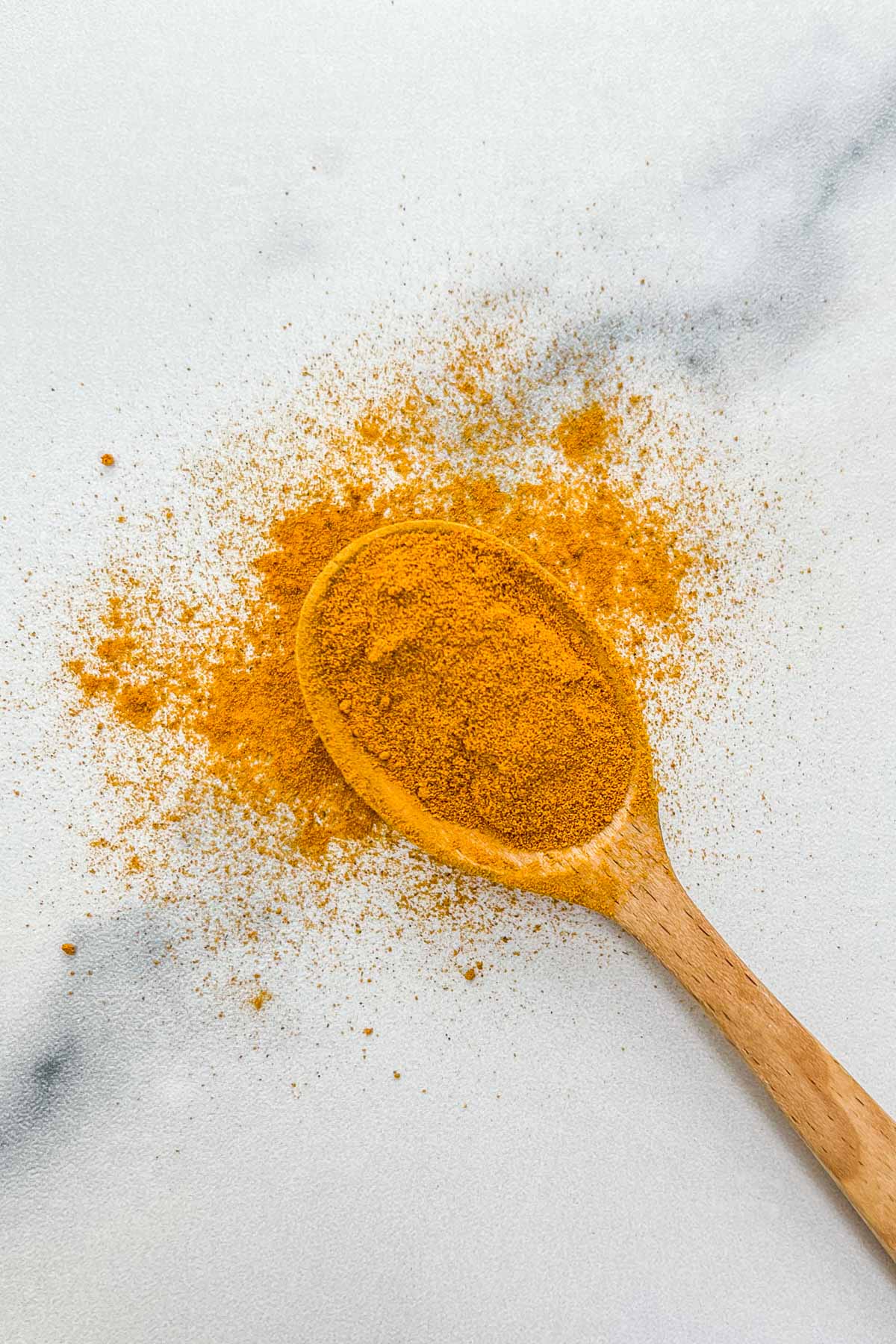 Turmeric on a wooden spoon.