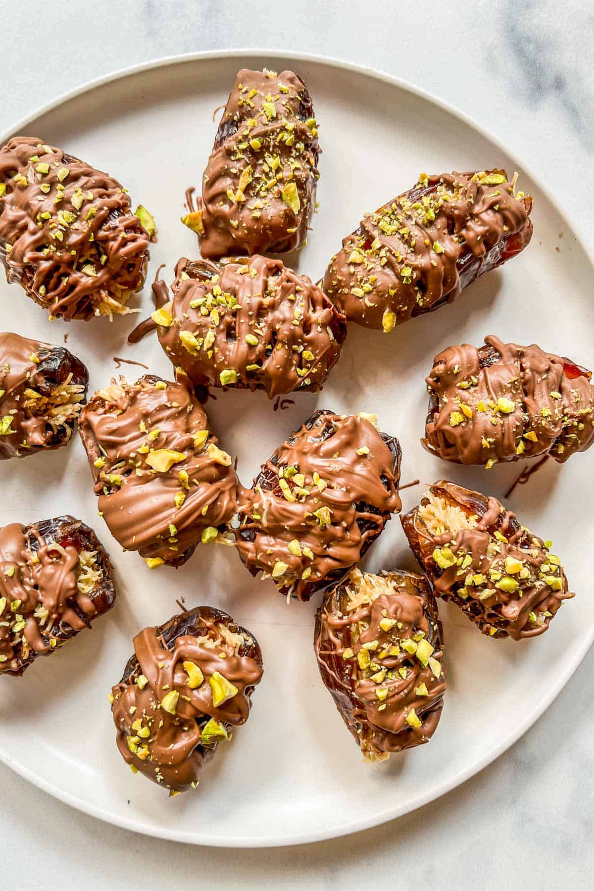 Dubai chocolate dates on a white plate.