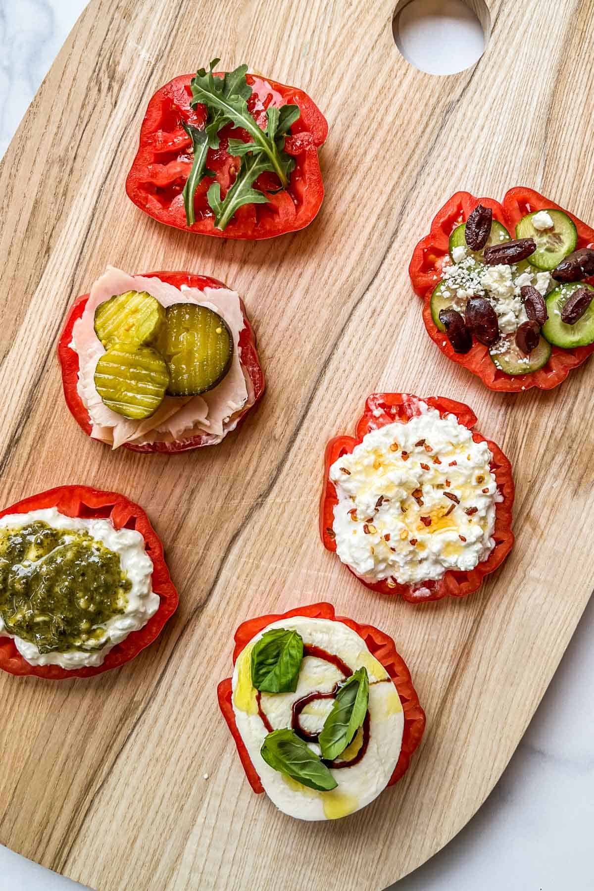 Heirloom tomato flight on a wooden cutting board.