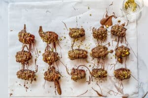 Dubai chocolate dates on a piece of parchment paper.