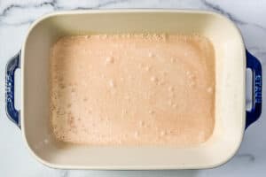 A mixture of coconut milk, Thai red curry, soy sauce, garlic, ginger, and rice wine vinegar in a casserole dish.